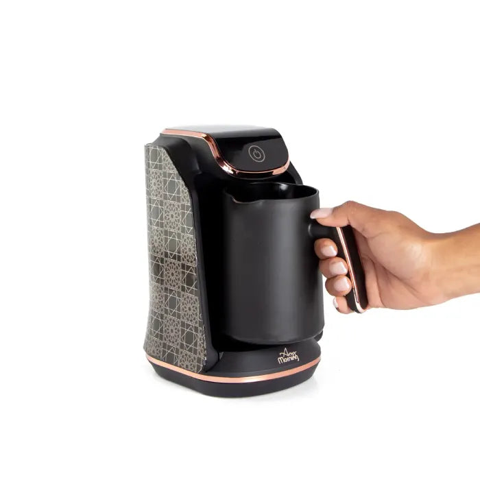 Sleek black electric Turkish coffee maker with geometric pattern and rose gold accents