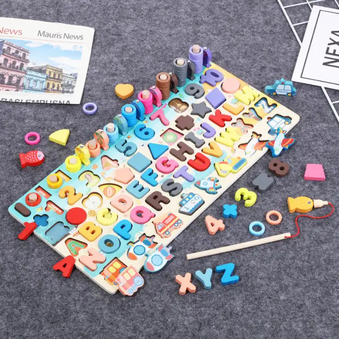 Montessori Math Board on grey carpet with scattered numbers, letters, rings, and fishing game pieces.