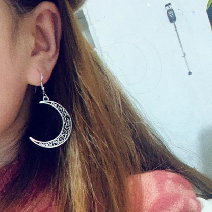 Crescent moon silver earring worn by a model, showcasing its stylish and elegant design.