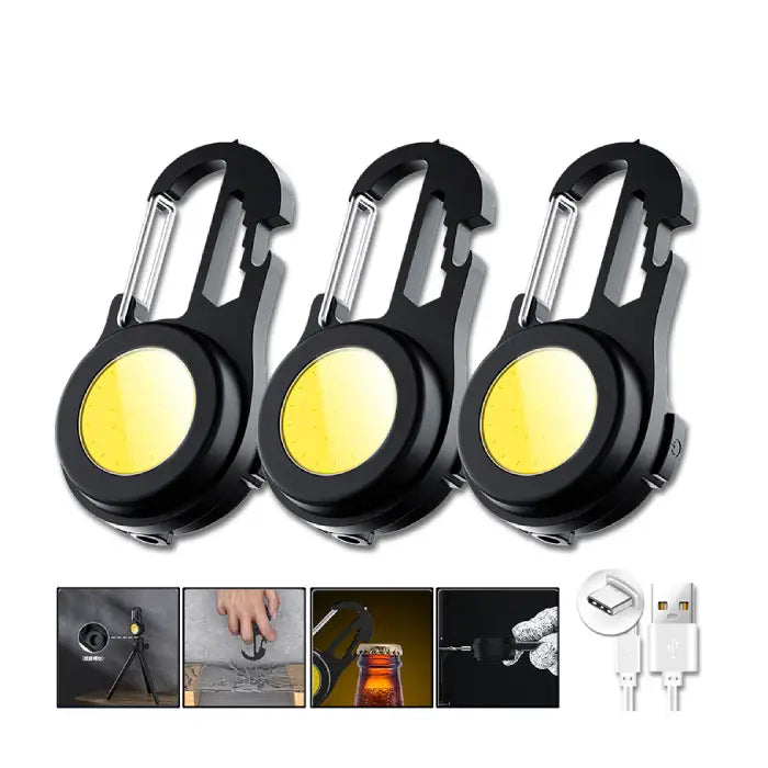 Three black carabiner-style LED keychain lights with bright yellow COB light panels and USB charging capability