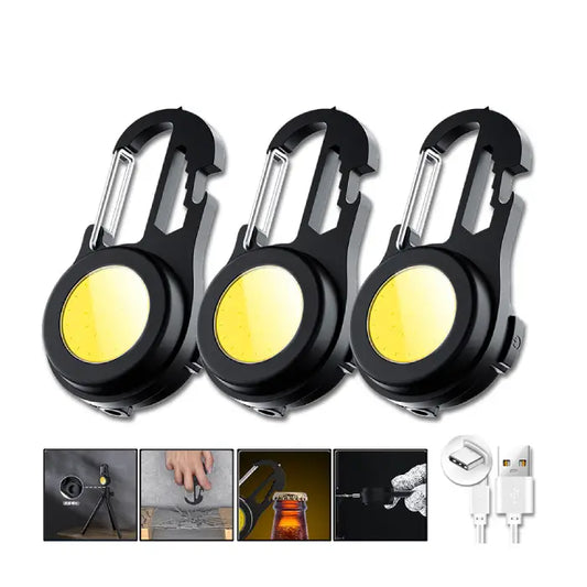 Three black carabiner-style LED keychain lights with bright yellow COB light panels and USB charging capability