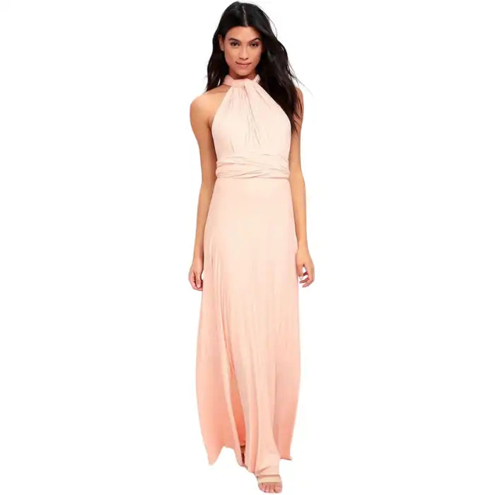  Multiway dress in blush pink featuring halter neckline and wrap-around bodice with a flowing fit.