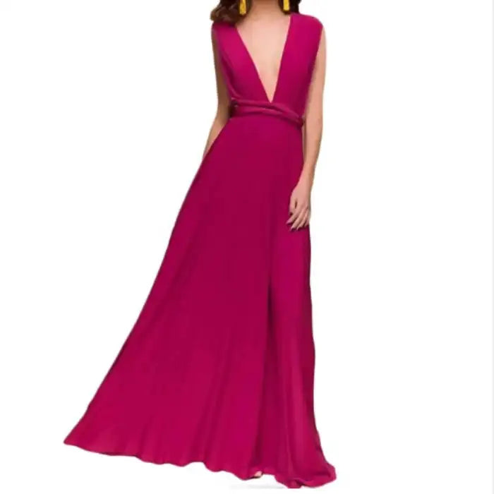  Multiway dress in magenta with deep plunge neckline, gathered waist and full-length flowing skirt.