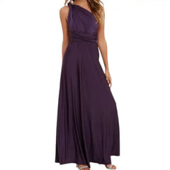 Multiway dress in deep purple styled as a one-shoulder wrap with pleated waist and full-length skirt.