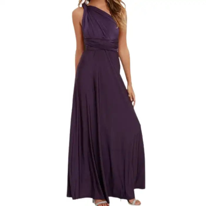  Multiway dress in deep purple styled as a one-shoulder wrap with pleated waist and full-length skirt.