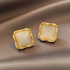 Natural white opal cat's eye earrings in braided gold square design, adding elegant shimmer and timeless gemstone appeal