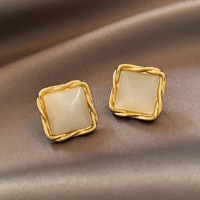 Natural white opal cat's eye earrings in braided gold square design, adding elegant shimmer and timeless gemstone appeal