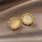Natural white opal cat's eye earrings featuring braided gold round borders, adding vintage charm and gentle gemstone glow