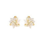 Natural white opal cat's eye earrings in gold leaf swirl motif shown on white background, delivering soft luminous elegance