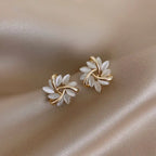 Natural white opal cat's eye earrings shaped like gold leaf clusters, offering a soft luminous floral-inspired elegance