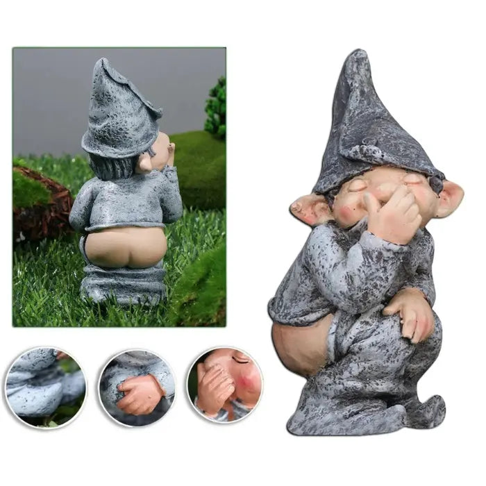 Naughty garden gnome statue with hat, crouching and mooning, holding nose in cheeky pose.