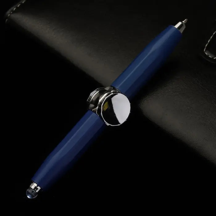 Navy Blue fidget spinner pen with stylus tips and chrome accents, displayed on black leather.