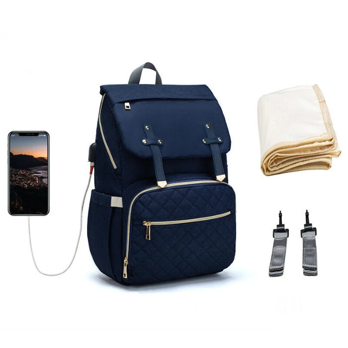 Navy blue quilted diaper backpack with USB charging port and golden accents perfect for sophisticated parents