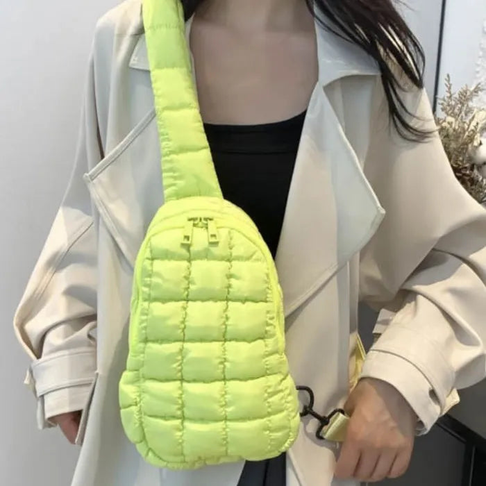 Neon green quilted sling bag worn with beige trench coat, adding a pop of color to outfit