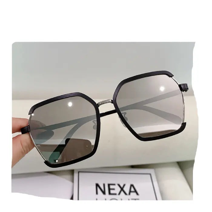 NEXA brand black geometric sunglasses with silver accents and gradient lenses showcased against white background