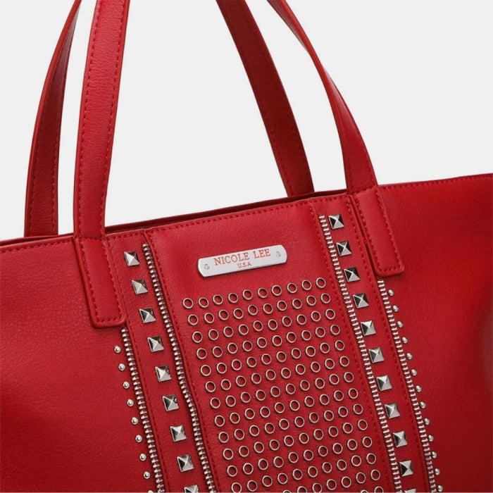 Close-up of Nicole Lee logo plate and premium studded detailing on red leather designer handbag for authentic branding