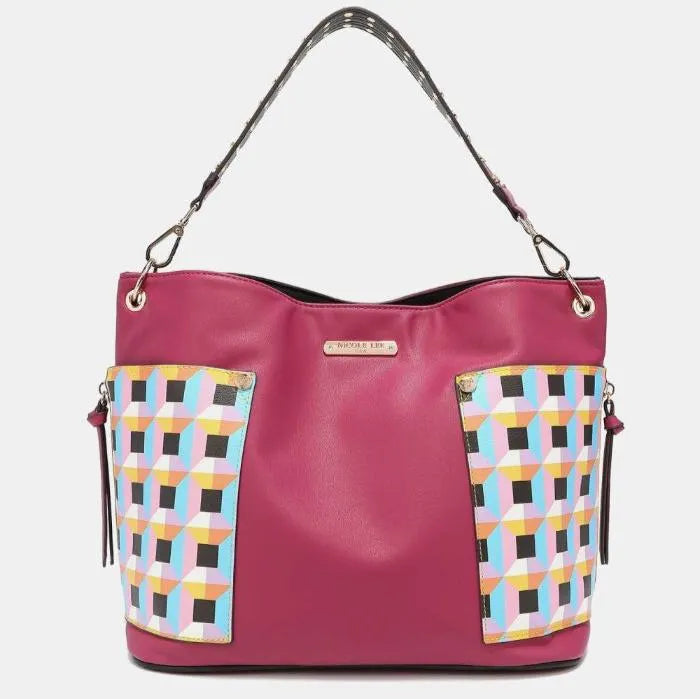 Designer pink hobo bag featuring geometric print side panels, branded metal plate, and polka dot shoulder strap