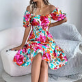 Off shoulder floral midi dress in pink orange blue print with smocked waist and puff sleeves.