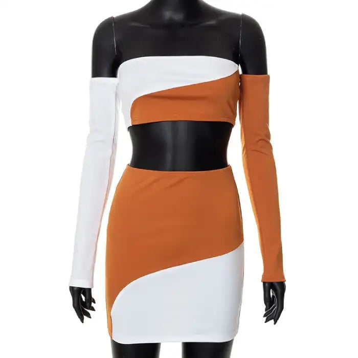 off-shoulder party dress styled as two-piece set on mannequin showing terracotta and white color-blocked design with asymmetric sleeve