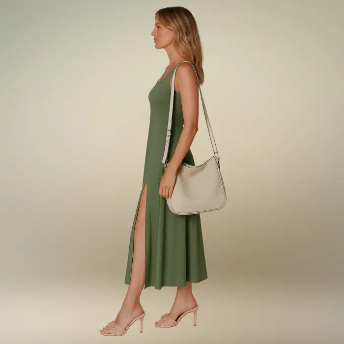 Side view of a woman in an olive green sleeveless A-line midi dress with a subtle side slit. Shop this comfortable scoop neck summer dress for effortless style and free shipping.