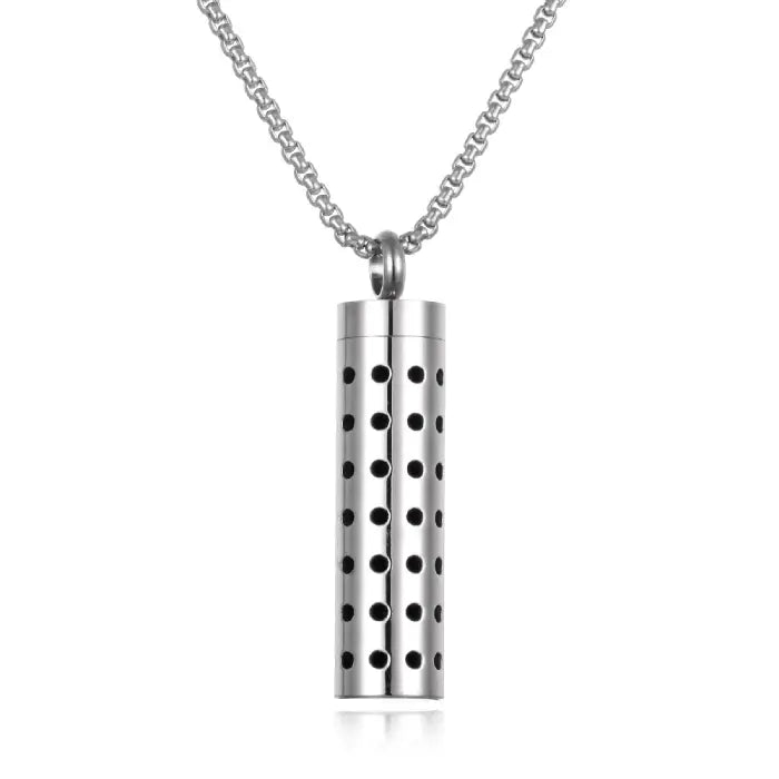 perforated aromatherapy pendant in red, crafted from titanium steel for essential oil diffusion.