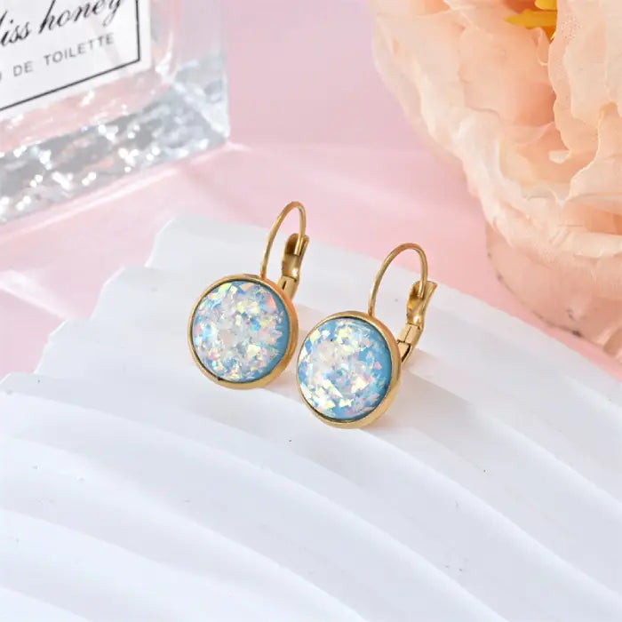 Opal earrings iridescent glitter leverback dangle gold shown in sky blue resin with holographic shimmer for a cool, luminous jewelry style.