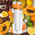 White fruit infuser water bottle surrounded by fresh tropical fruits including papaya grapes citrus and kiwi for healthy hydration