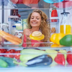 organized fridge with a lemon storage box, surrounded by fresh fruits and vegetables