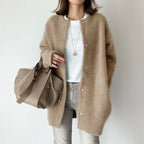 Oversized knit cardigan in classic camel hue styled with basics for timeless everyday comfort wear