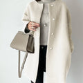 Oversized knit cardigan with button front and longline silhouette styled for polished yet cozy layering
