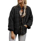  Oversized quilted zip jacket in black with soft texture and casual fit, front view.
