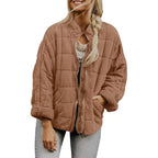  Oversized quilted zip jacket in brown with collarless neckline, side pockets, and suede texture, front view.