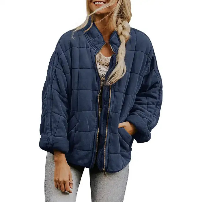  Oversized quilted zip jacket in navy blue with casual fit and collarless neckline, front view.