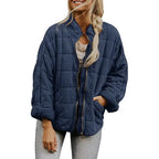  Oversized quilted zip jacket in navy blue with casual fit and collarless neckline, front view.