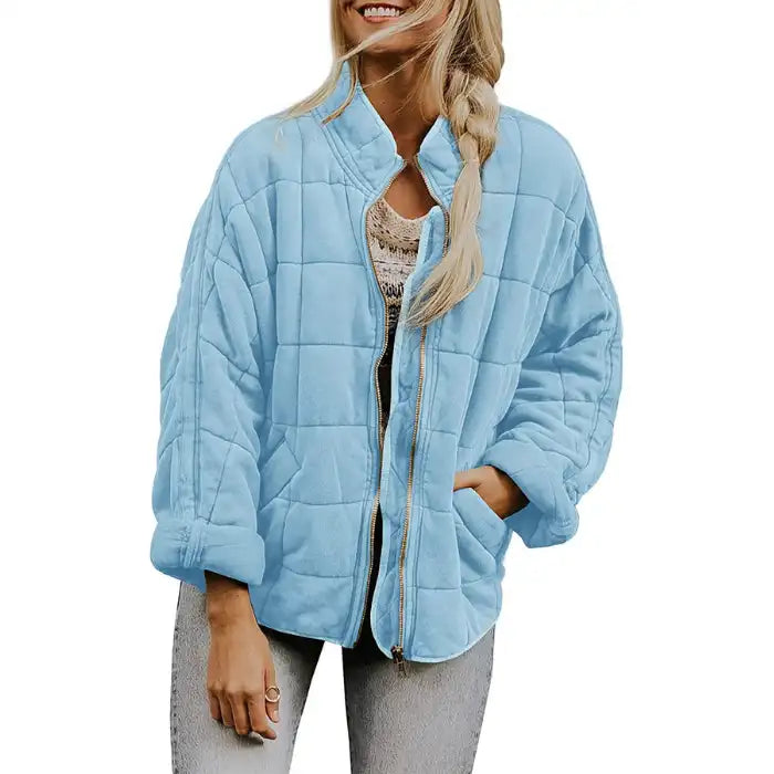  Oversized quilted zip jacket in sky blue with square quilting and zipper closure, front view.