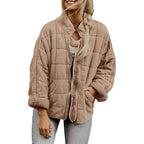 Oversized quilted zip jacket in taupe with soft suede texture and side pockets, front view.