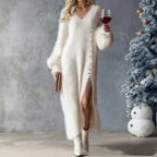 Oversized sweater dress with slit styled in white knit offering warmth comfort and elevated winter fashion appeal.