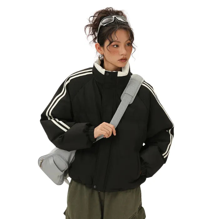 Padded Puffer Jacket in black with white stripes styled with crossbody bag and casual streetwear.