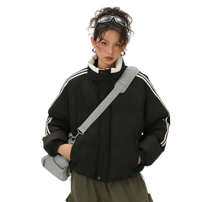 Black Padded Puffer Jacket with white collar stripes modeled with green cargo pants and grey bag.