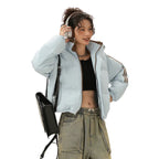 Light blue Padded Puffer Jacket worn open with black crop top and cargo pants for casual street style.