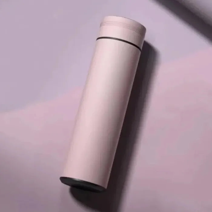 Pale pink insulated water bottle with black base on gradient pink background