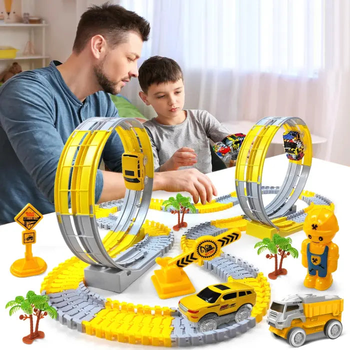 Father and son playing with a yellow loop track race car set featuring engineering signs and props.