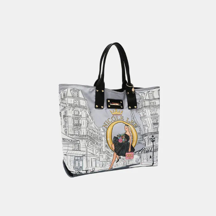 Side view of tote bag with Paris-inspired artwork, black handles, and gold hardware details