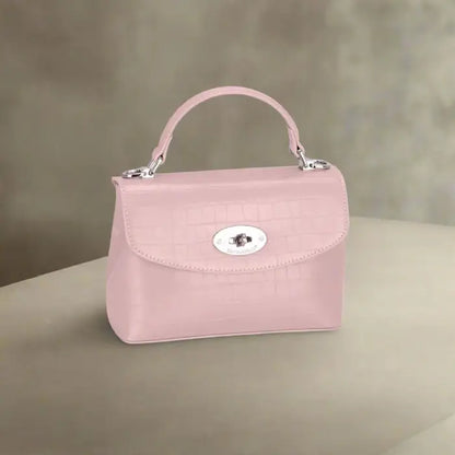 Pastel pink crocodile-textured leather handbag with silver detailing for elegant women's fashion.