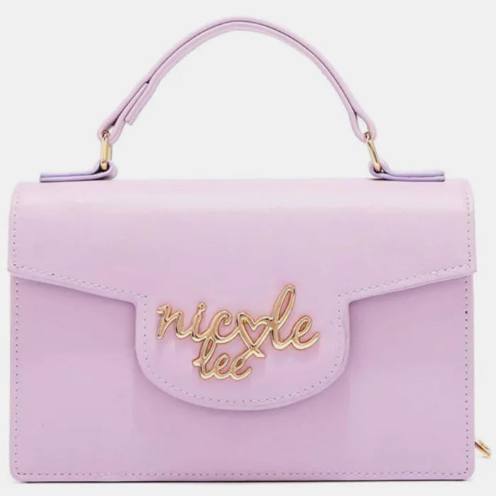 Pink structured handbag with top handle and gold cursive logo embellishment on front flap