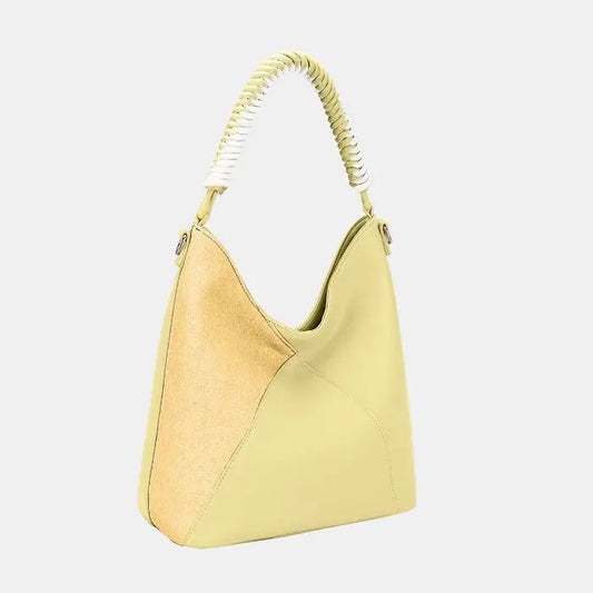 Pastel yellow hobo bag with braided handle, featuring two-tone design with suede accent panel