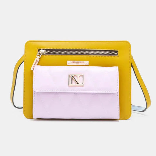 Nicole Lee crossbody handbag featuring yellow exterior and pink quilted front pocket with signature NL logo emblem