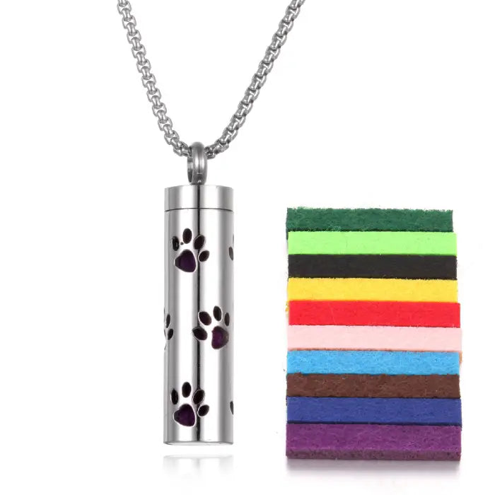 Paw print stainless steel diffuser pendant with colorful felt pads for essential oil aromatherapy use.