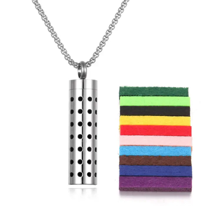 Perforated design stainless steel aromatherapy pendant with colorful felt pads for essential oil use.