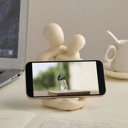 Modern figure-themed phone holder, combining utility and art for a stylish desk or workspace accessory.